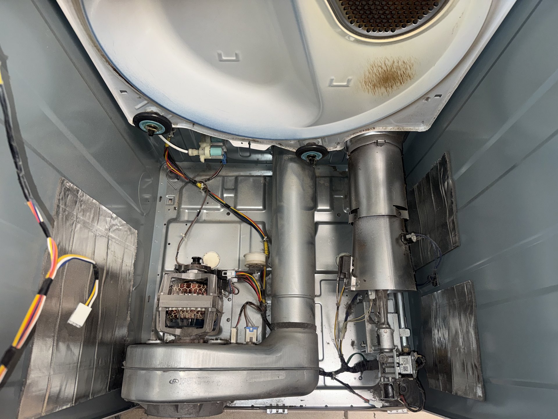 Dryer blower housing and motor area with lint accumulation before cleaning