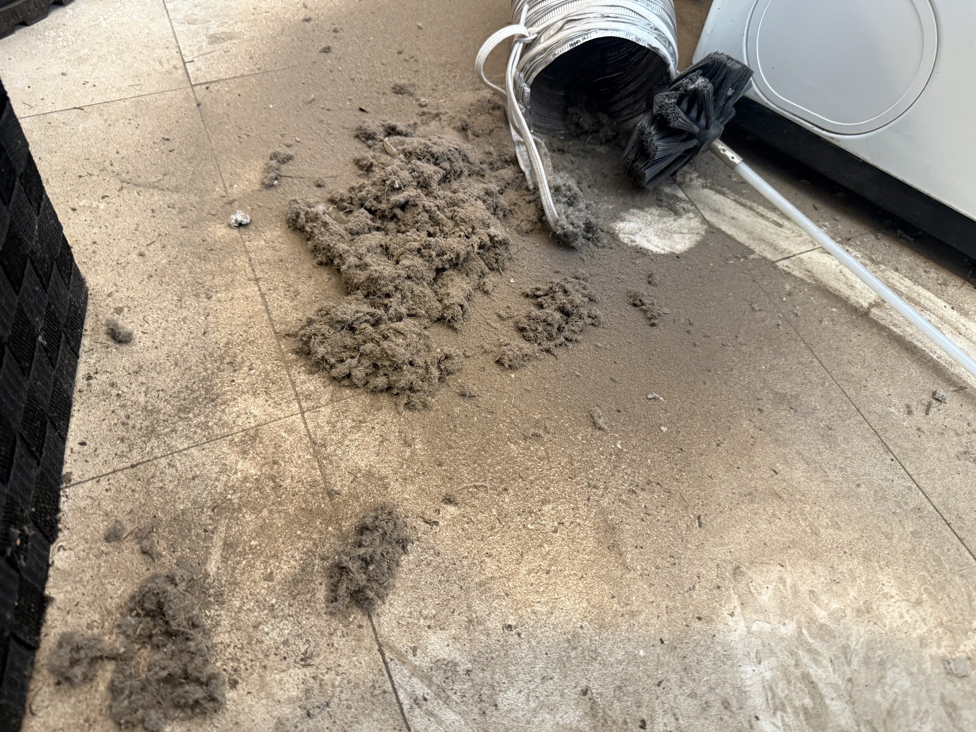 Compressed lint clog removed from dryer during Family Touch dryer cleaning
