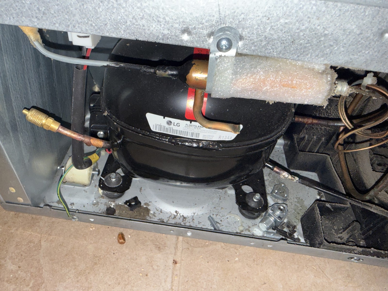 LG refrigerator compressor with frost on the suction refrigerant line during a sealed-system diagnosis