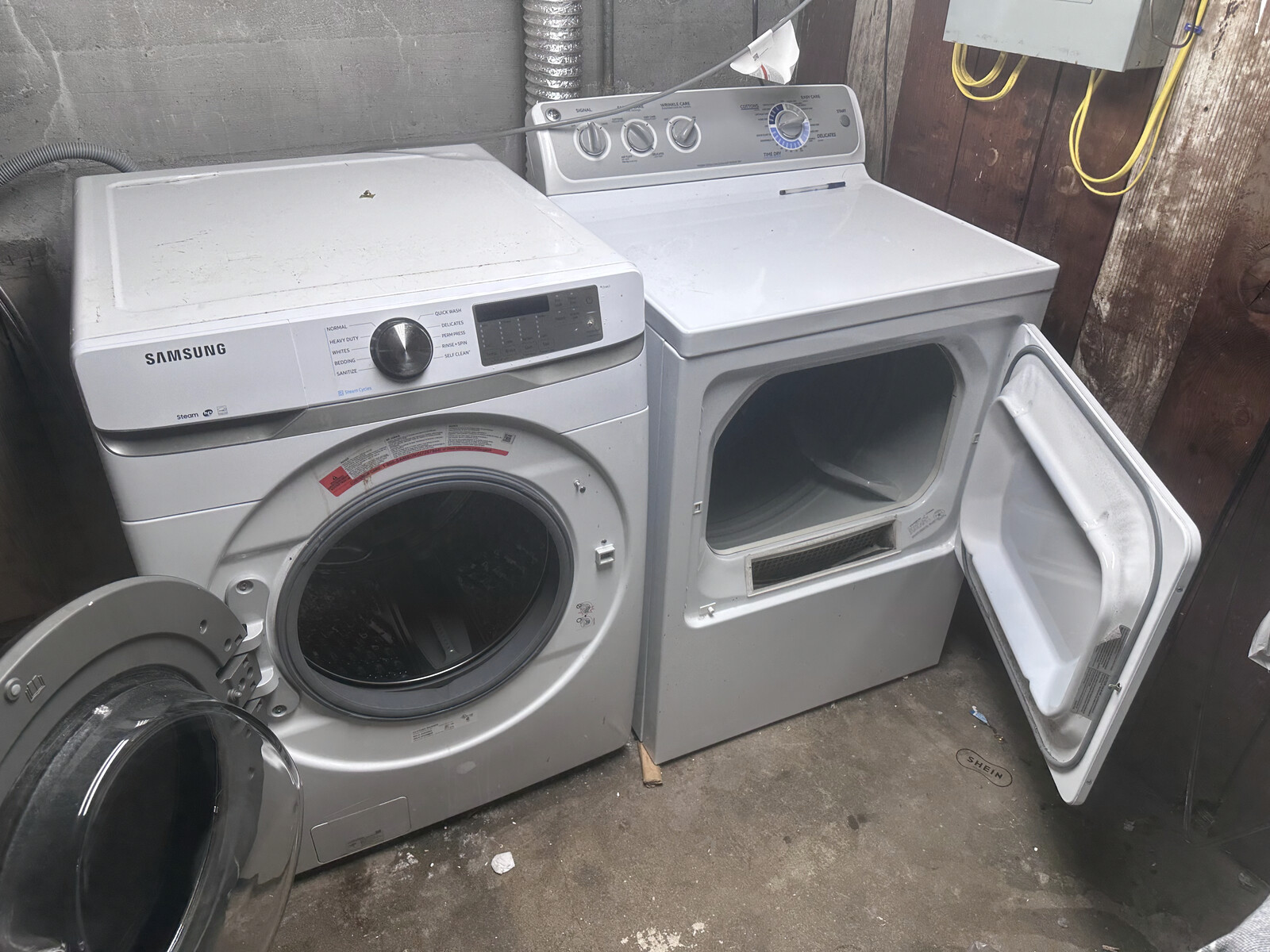 Samsung front-load washer and matching top-load dryer set installed in a homeowner's basement, photographed during a service call